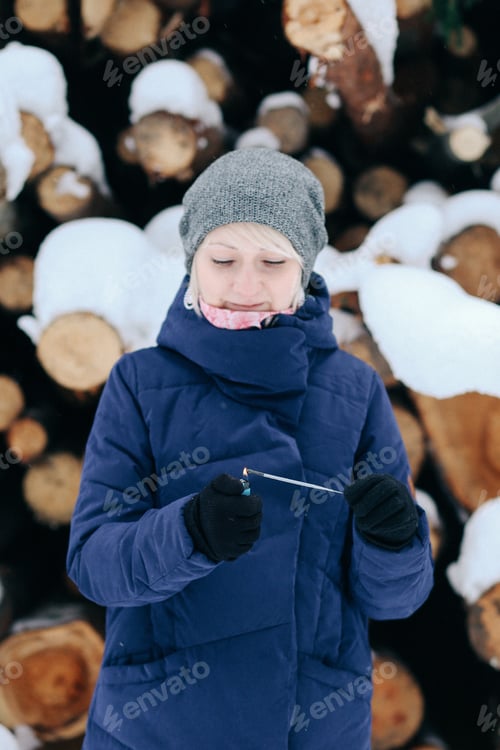 Preview: Woman Lights a Sparkler in the Snow
