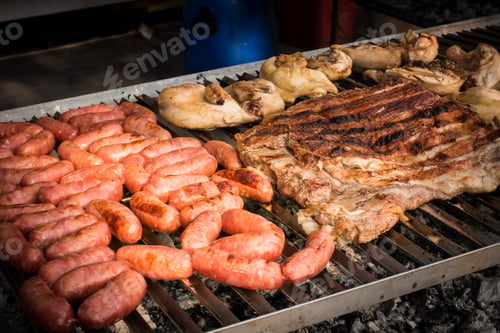 Preview: Meat baked on the grill. Sausages homemade sausages on the grill. Street food.