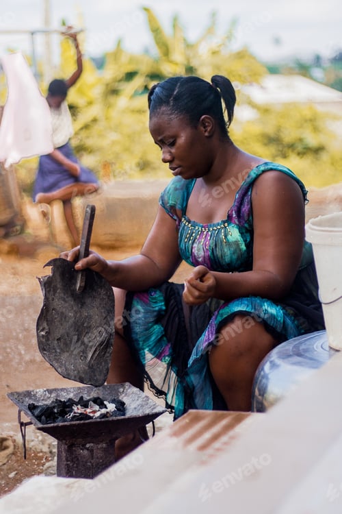 Preview: An adult fanning a coal of fire