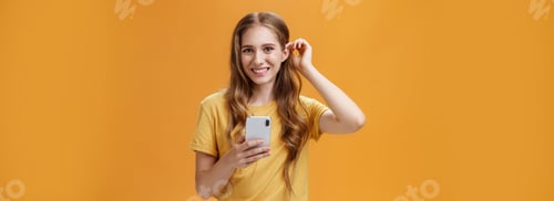 Preview: Waist-up shot of cute and friendly-looking nice young girl with wavy hairstyle putting hair strand