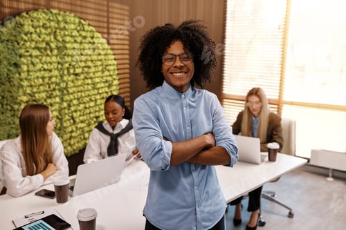 Preview: Confident African American businessman standing in modern eco-friendly office