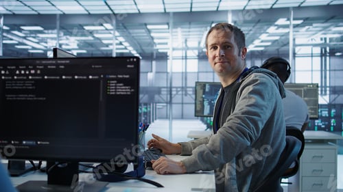 Preview: Upbeat technician safeguarding data center hardware, securing system