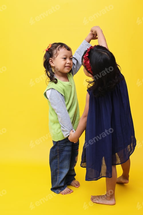 Preview: Cute little Asian girl dancing with her friend