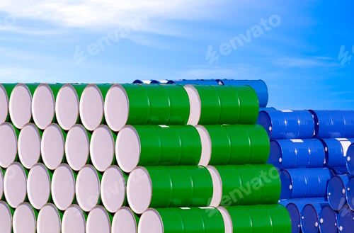 Preview: Pile of many colorful oil drums stacked in industrial yard area against blue sky background