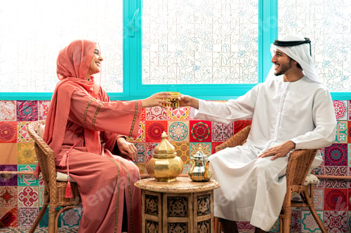 Preview: Young couple from Emirati spending time in a cafe