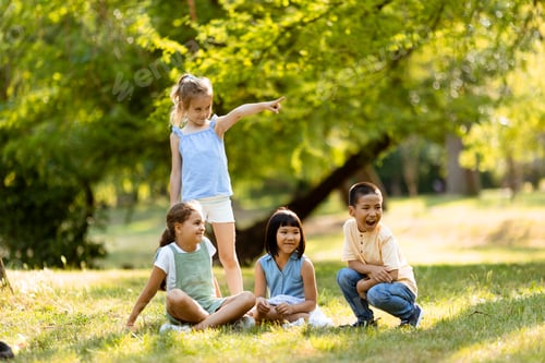 Preview: Group of asian and caucasian kids having fun in the park