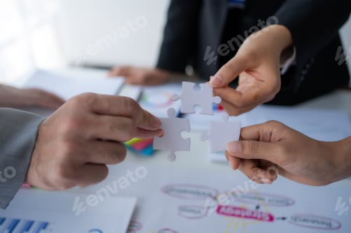 Preview: Group of business people holding jigsaw puzzles, team solving puzzles, planning together.