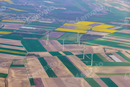 Preview: Colorful farmland landscape with wind turbines seen from above at Vienna, Austria