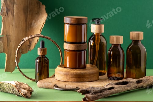 Preview: Glass brown containers for cosmetics with wooden lids. Cream, dropper bottle and lotion. Green