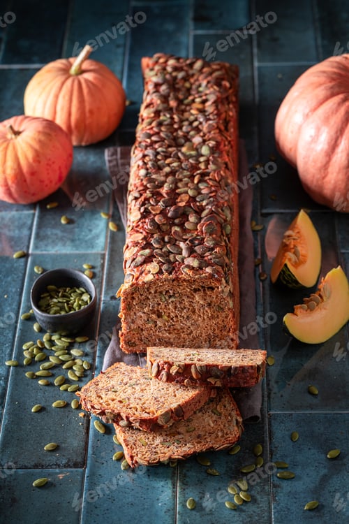 Preview: Homemade pumpkin bread with orange squashes and seeds.