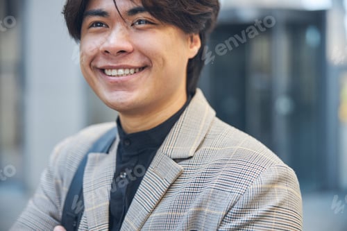 Preview: Handsome young man looking away and smiling