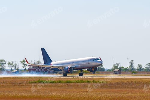 Preview: Passenger plane taking off from runway at airport on sunny day