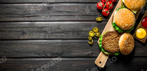 Preview: Burgers with different sauces,jalapenos and tomatoes.