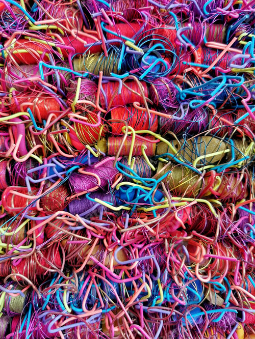 Preview: Vertical closeup shot of a heap of bright colorful string