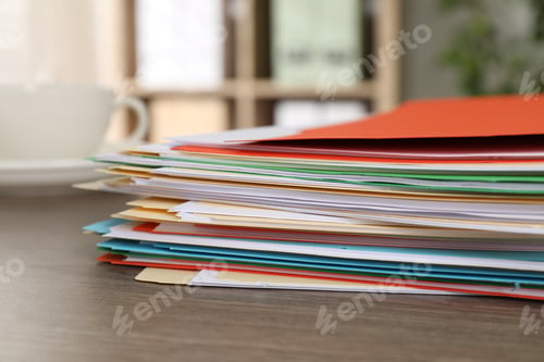 Preview: Many folders with documents and drink on wooden desk, closeup