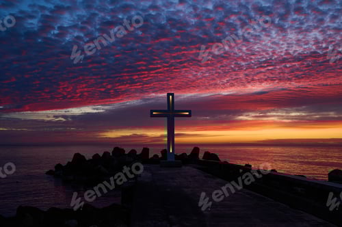 Preview: Christian Holy cross early in the morning at sunrise. The large cross stands on the edge of a