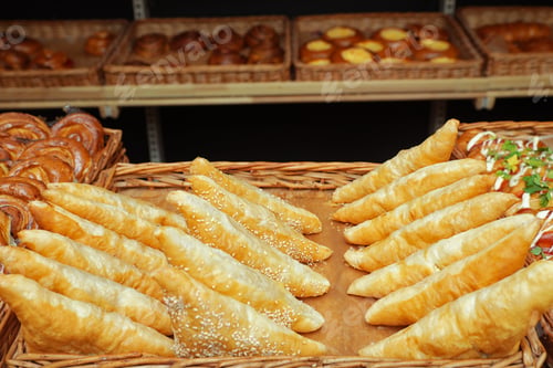 Preview: Tray with fresh puff pastry turnovers on bakery showcase