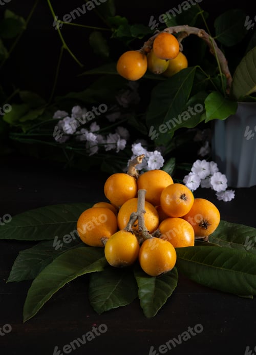Preview: medlars freshly picked with leaves on wooden background