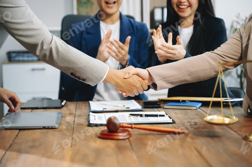 Preview: business people and lawyers discussing contract papers sitting at the table.