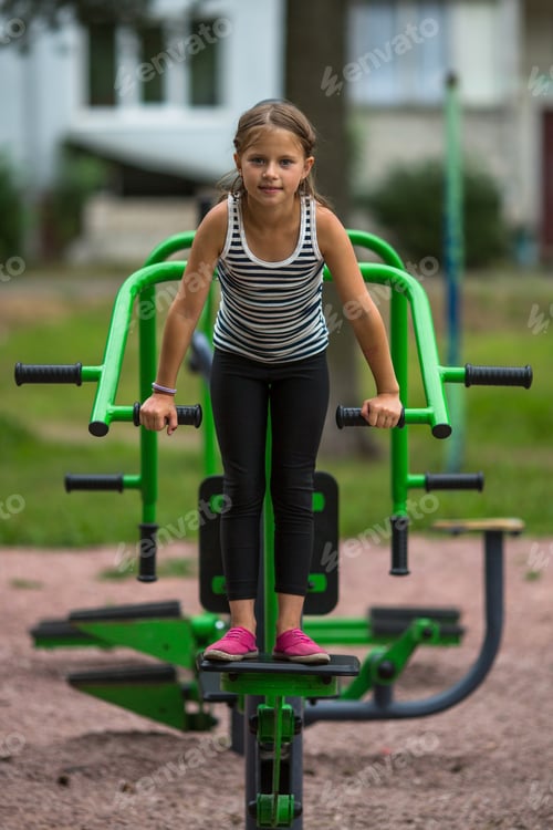 Preview: Little Cute Girl Is Engaged In Sports Equipment Outdoor.
