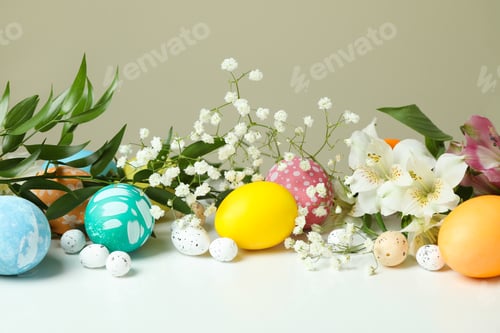 Preview: Easter eggs and beautiful flowers on white table
