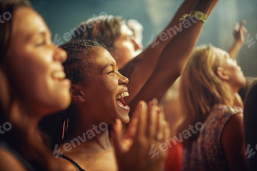 Preview: Young girls in an audience enjoying their favourite bands performance