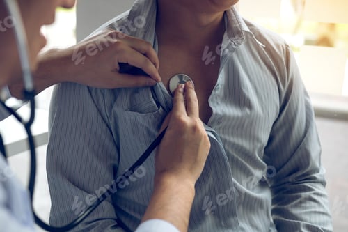 Preview: Asian doctor is using a stethoscope listen to the heartbeat of the elderly patient.