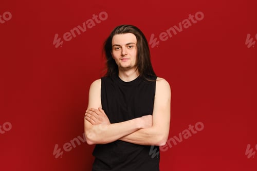 Preview: Studio portrait of young handsome man with long black hair