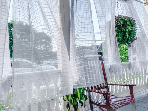 Preview: A cool summer breeze parts the curtains on a light and bright front porch.