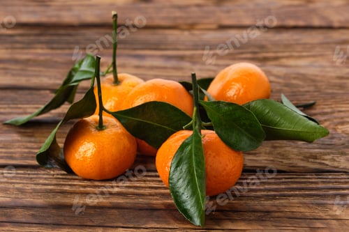 Preview: Fresh mandarines with leaves on wooden background