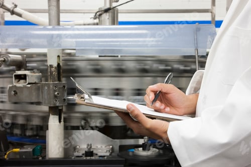 Preview: Closeup of a hand and a clipboard, technician checks inventory on a production line