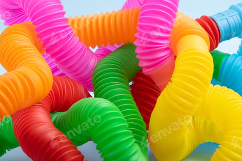 Preview: Closeup photography of multicolored curved pop tubes.Trendy antistress toy for children.