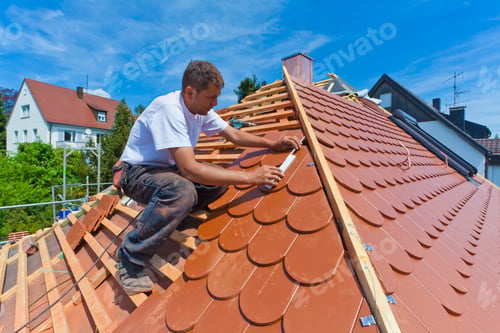 Preview: Germany, Baden-Wuerttemberg, Stuttgart, Mid adult man measuring roof tile
