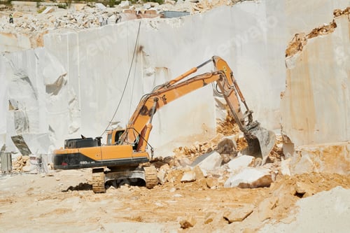 Preview: Industrial machine grabbing one of several huge white marble rocks