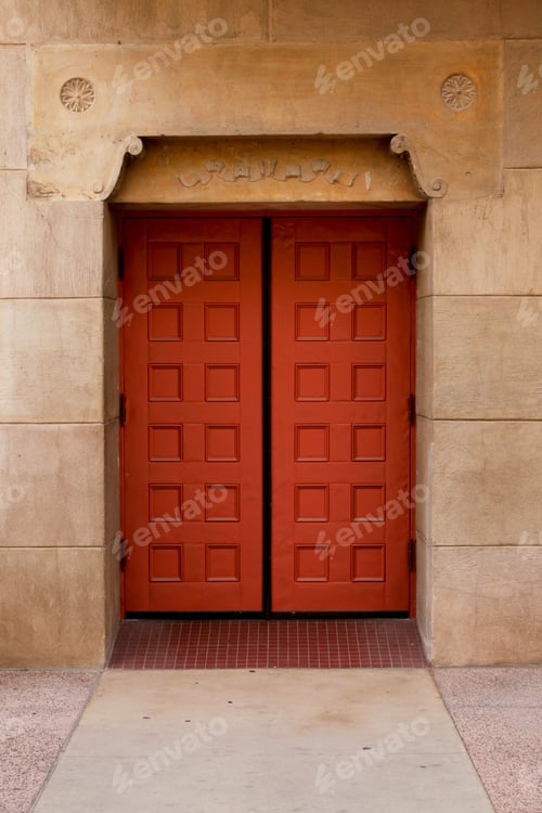 Preview: Vertical shot of an old building with red doors