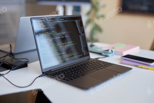 Preview: Laptop with codes on screen standing on desk of highschool student