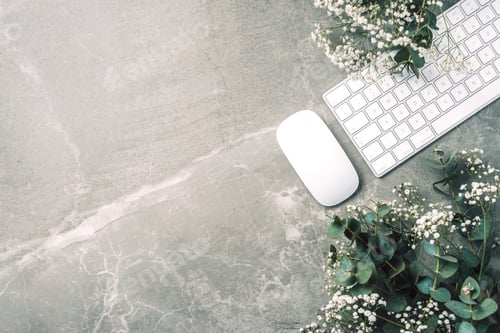 Preview: Feminine workspace. White computer keyboard, mouse, gypsophila flowers, eucalyptus flowers on marble