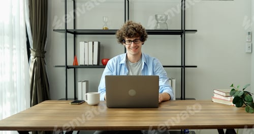 Preview: Cheerful Man Works from Home on Laptop