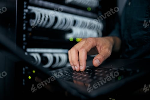Preview: Hands, laptop and typing in server room, man and inspection with coding, analysis and night for pro