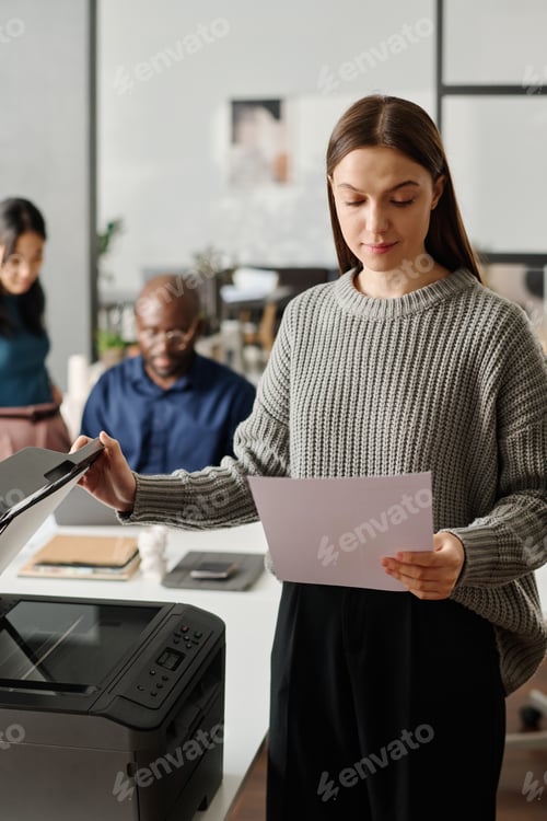Preview: Young Manager Checking Printed Documents
