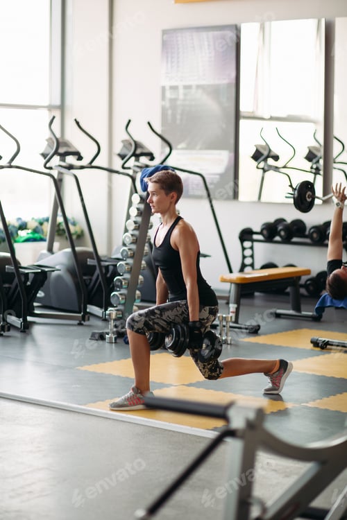 Preview: View of pretty healthy woman doing exercises with dumbbells