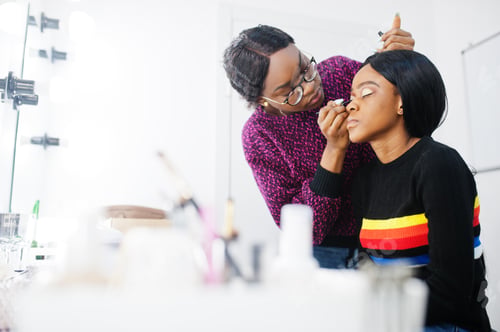 Preview: African American woman applying make-up