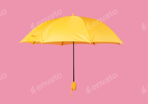 Preview: Opened yellow umbrella isolated on pink background