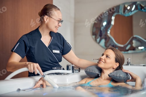 Preview: Contented lady receiving an underwater shower massage