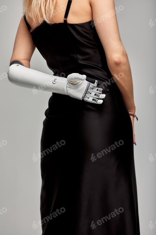 Preview: Cropped studio portrait of charming girl with disability wearing sensory bionic prosthetic arm
