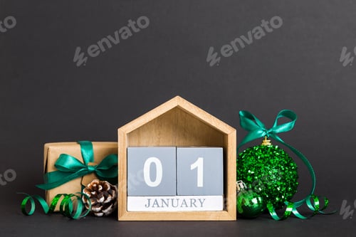 Preview: 1 january. Christmas composition on colored background with a wooden calendar,