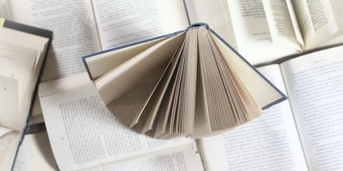 Preview: stack of books, close up. Open book on the table in library. Back to school concept. Open book on ta