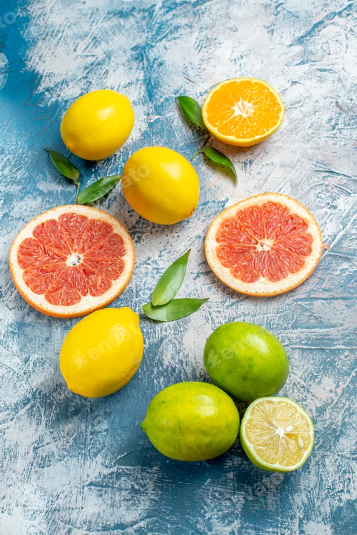 Preview: top view cut grapefruits lemons on blue white background