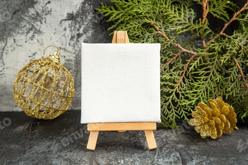 Visualização: front view mini canvas on wooden easel pine branch xmas ornaments on grey background