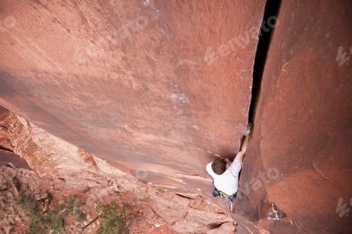 Preview: Rock climber scaling boulder crack